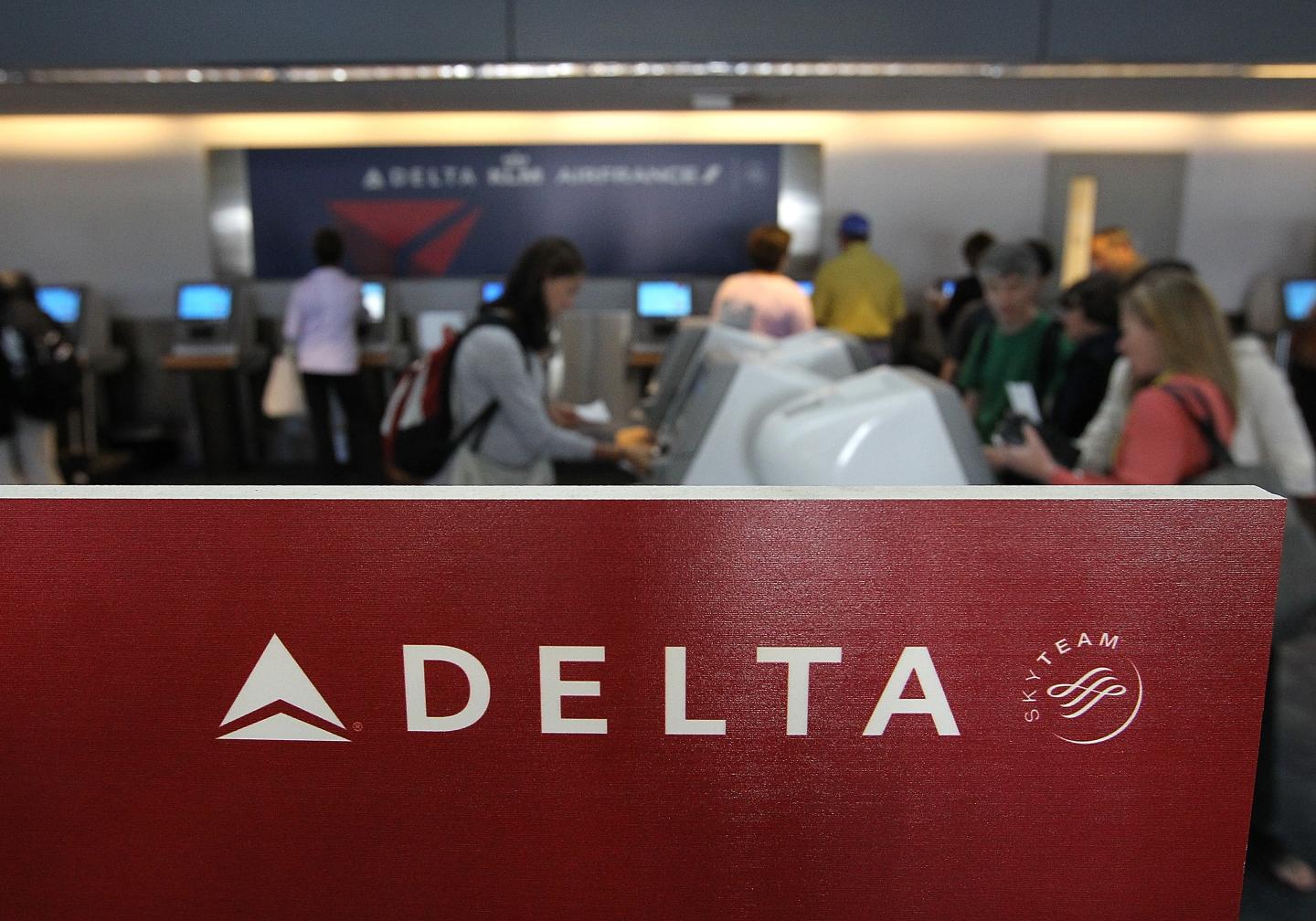 Delta Air Lines passengers use kiosks to check in for flights at San Francisco International Airport in California.