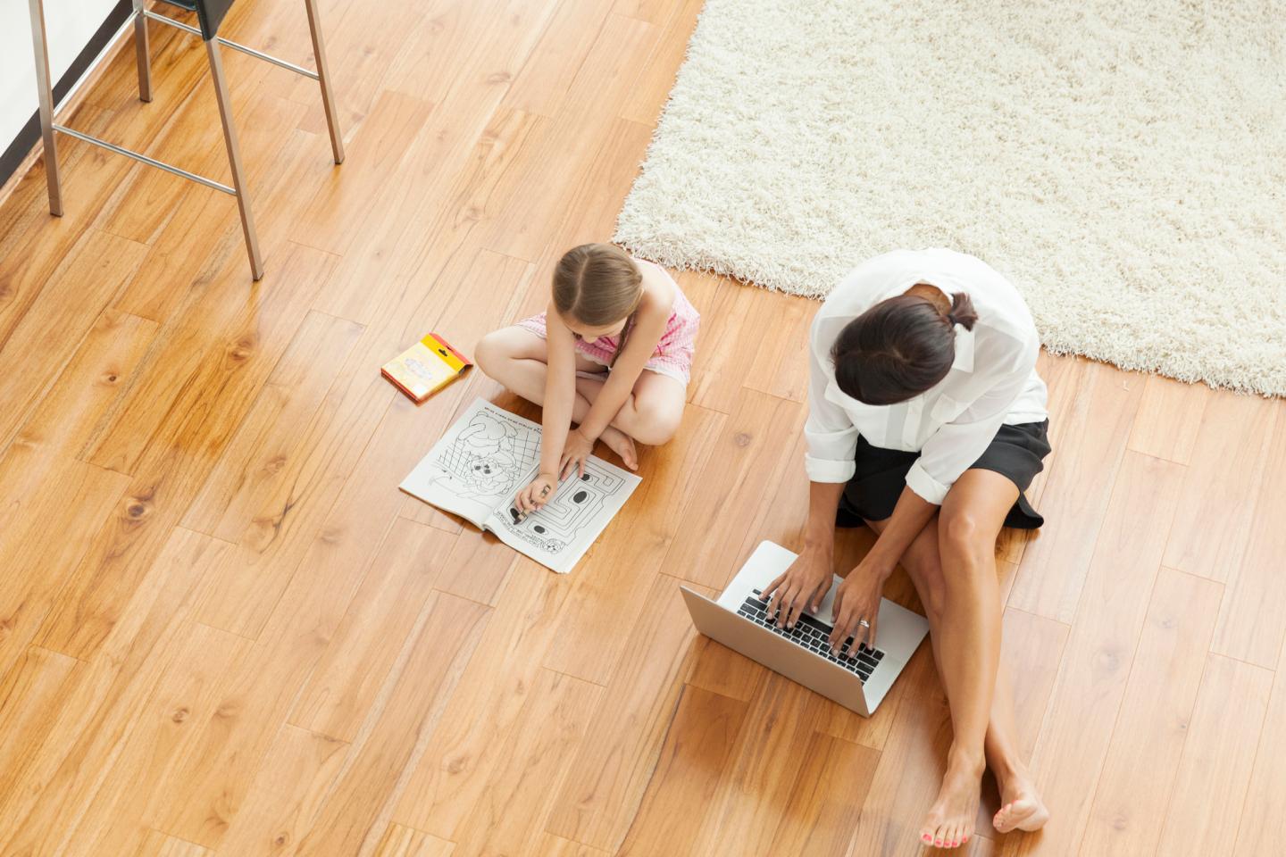 Mother and girl (6-7) on floor in living room