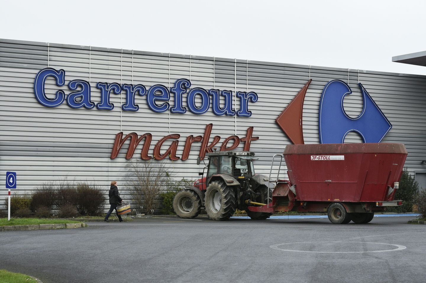 A picture taken on February 4, 2016 shows a truck in front of a Carrefour supermarket in Dol-de-Bretagne, western France, as farmers block the entrance to the supermarket during a demonstration against the falling prices of their agricultural products on February 4, 2016. / AFP / DAMIEN MEYER (Photo credit should read DAMIEN MEYER/AFP/Getty Images)