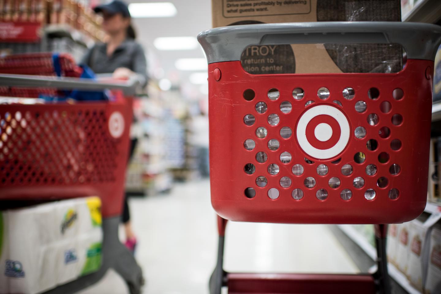 Customers use Target Corp. shopping carts to move products inside a company's store in Chicago, Illinois, U.S., on Monday, May 16, 2016.