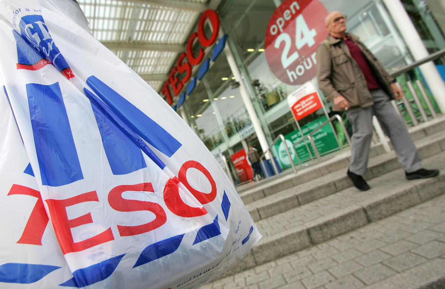 Customers leave a Tesco supermarket in w