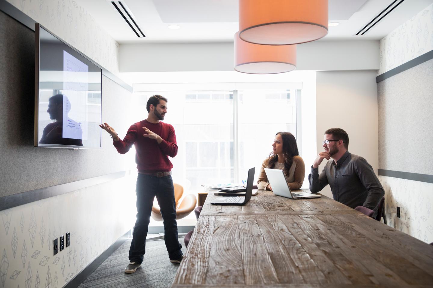 Businessman talking to colleagues in office meeting