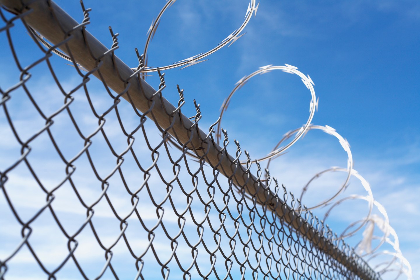 Barbed wire fence and blue sky