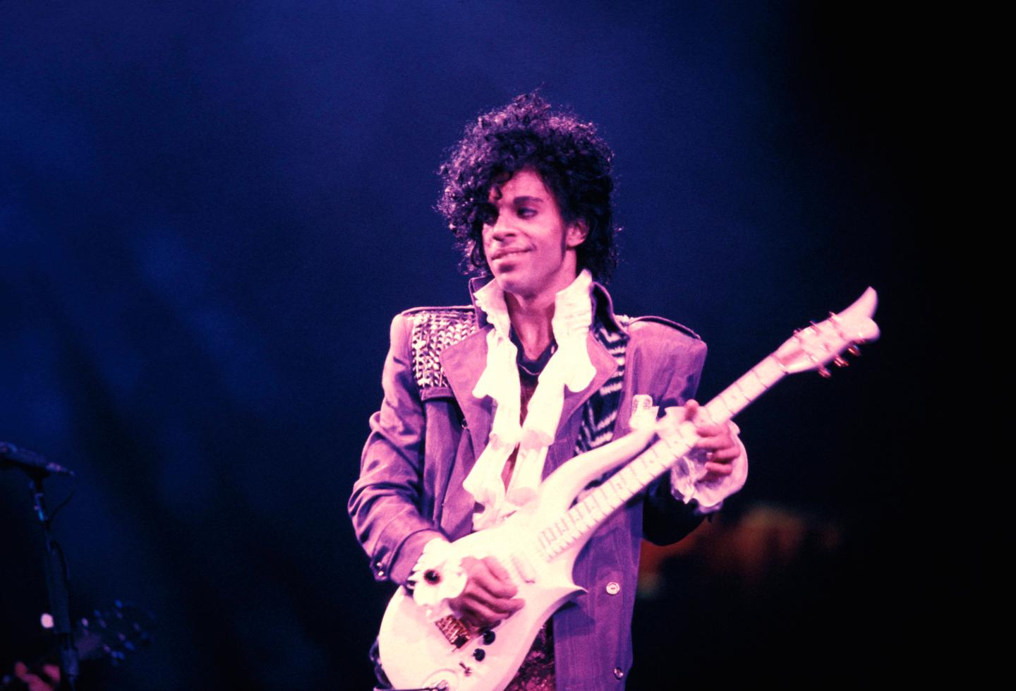 Prince performs on stage during the Purple Rain Tour.