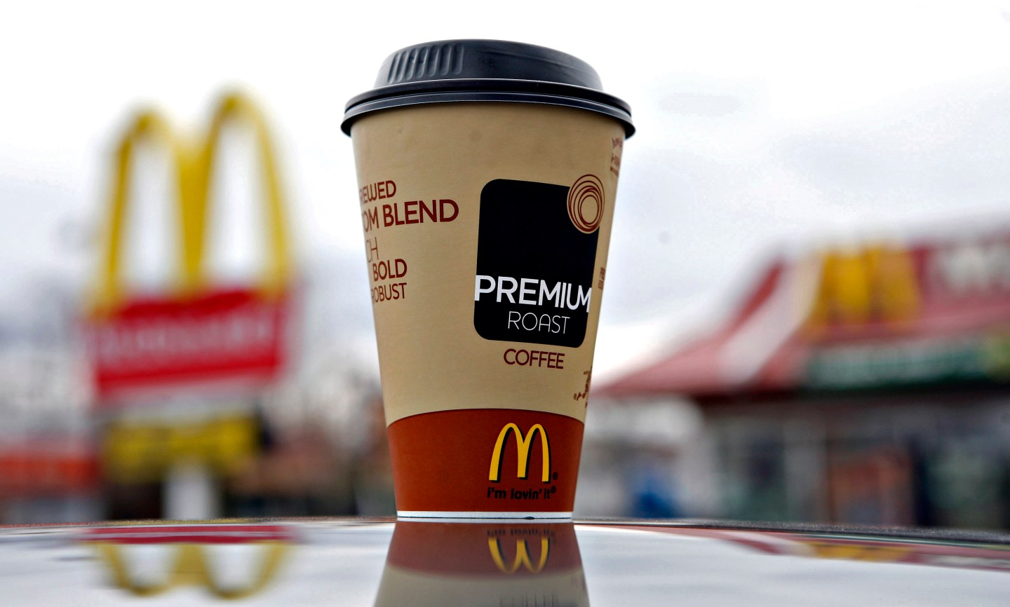 A cup of McDonald's Premium Roast coffee is arranged for a p