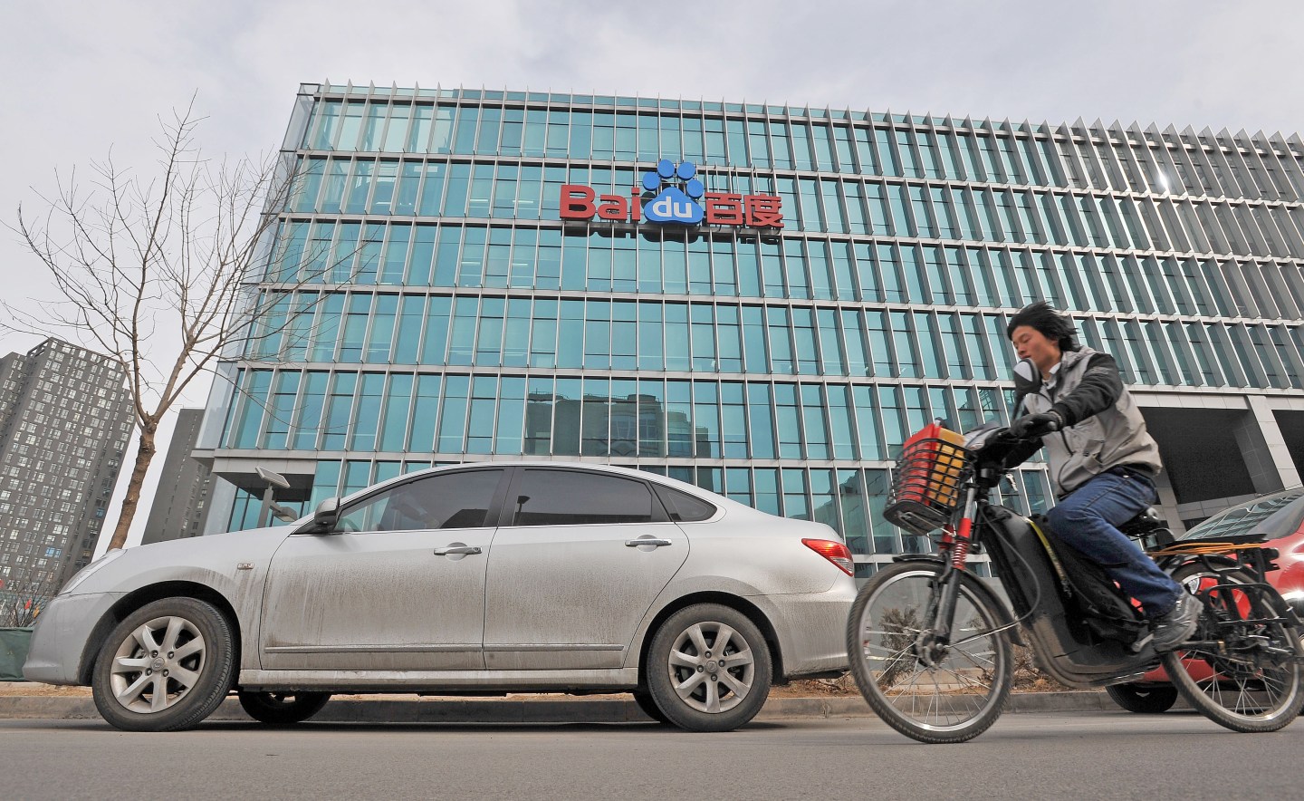 Chinese motorists pass  by the Chinese W