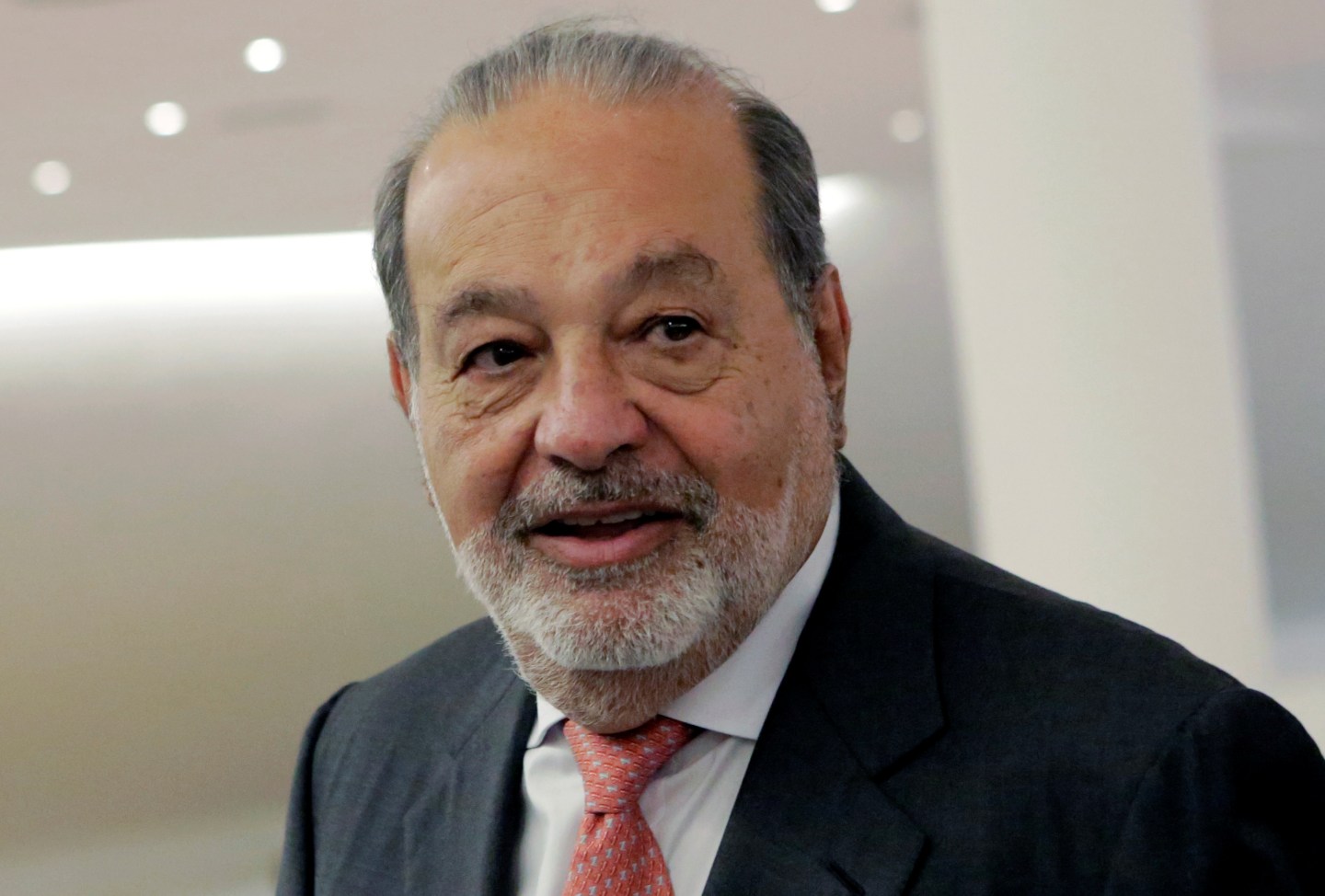 Mexican tycoon Carlos Slim walks after he launched a free online platform for education with free access to mobile WiFi connections to the Internet on his Infinitum service during a news conference at Soumaya museum in Mexico City