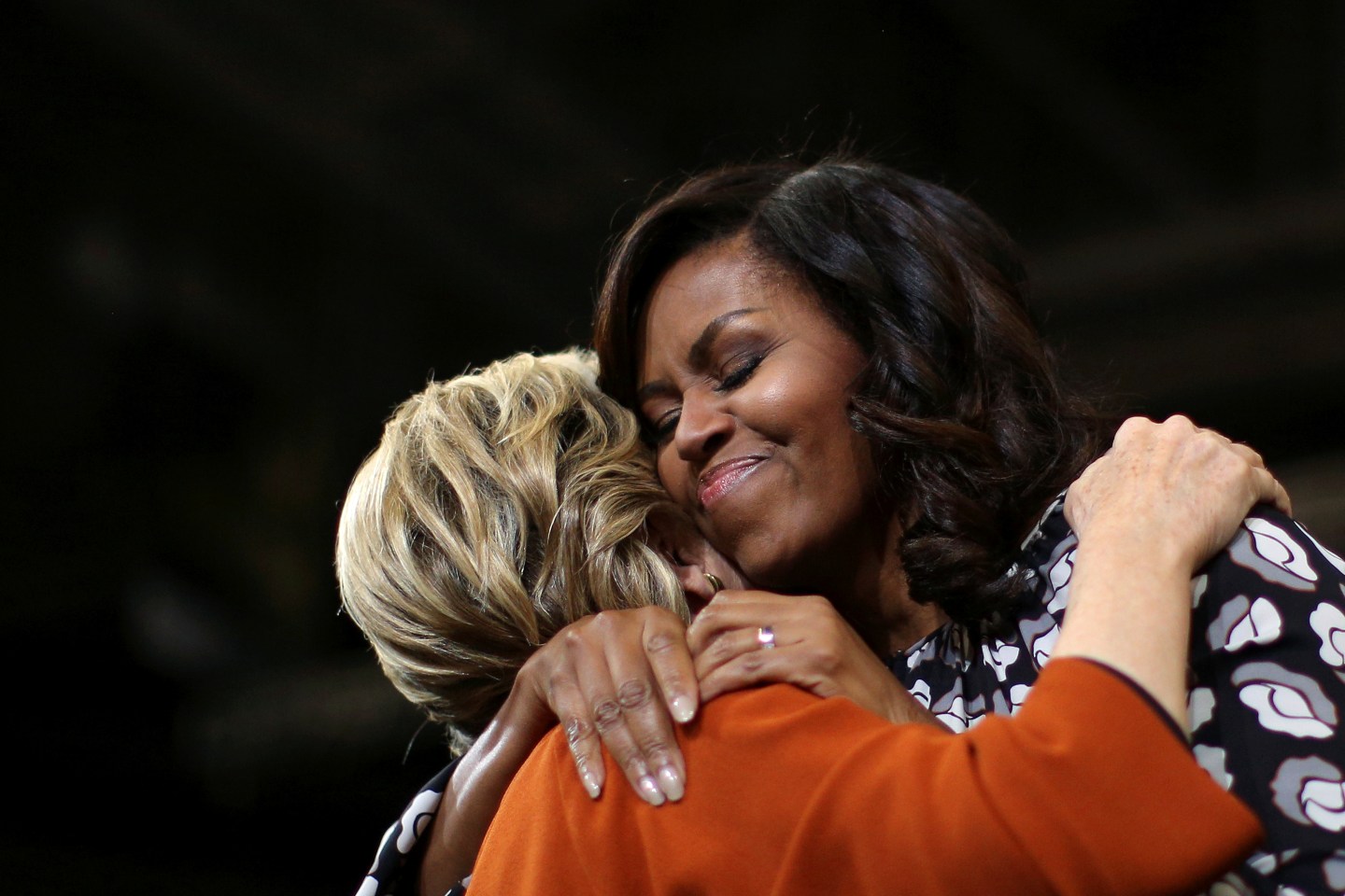 U.S. first lady Michelle Obama embraces U.S. Democratic presidential candidate Hillary Clinton as they arrive at a campaign rally in Winston-Salem, North Carolina, U.S.