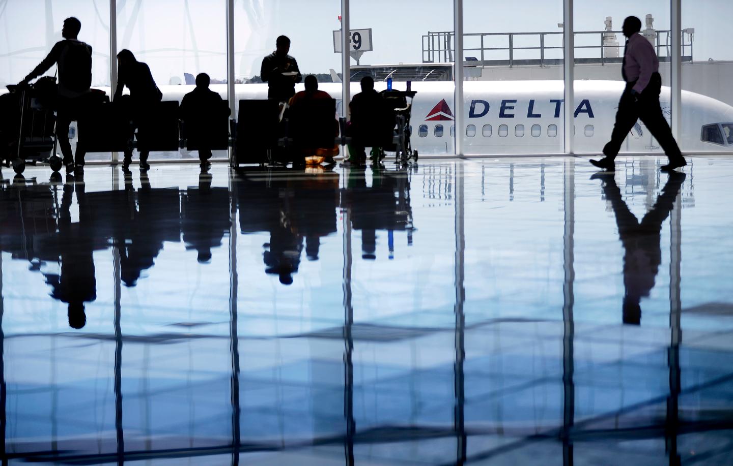 A Delta Air Lines jet sits at a gate at Hartsfield-Jackson Atlanta International Airport, in Atlanta, Thursday, Oct. 13, 2016.