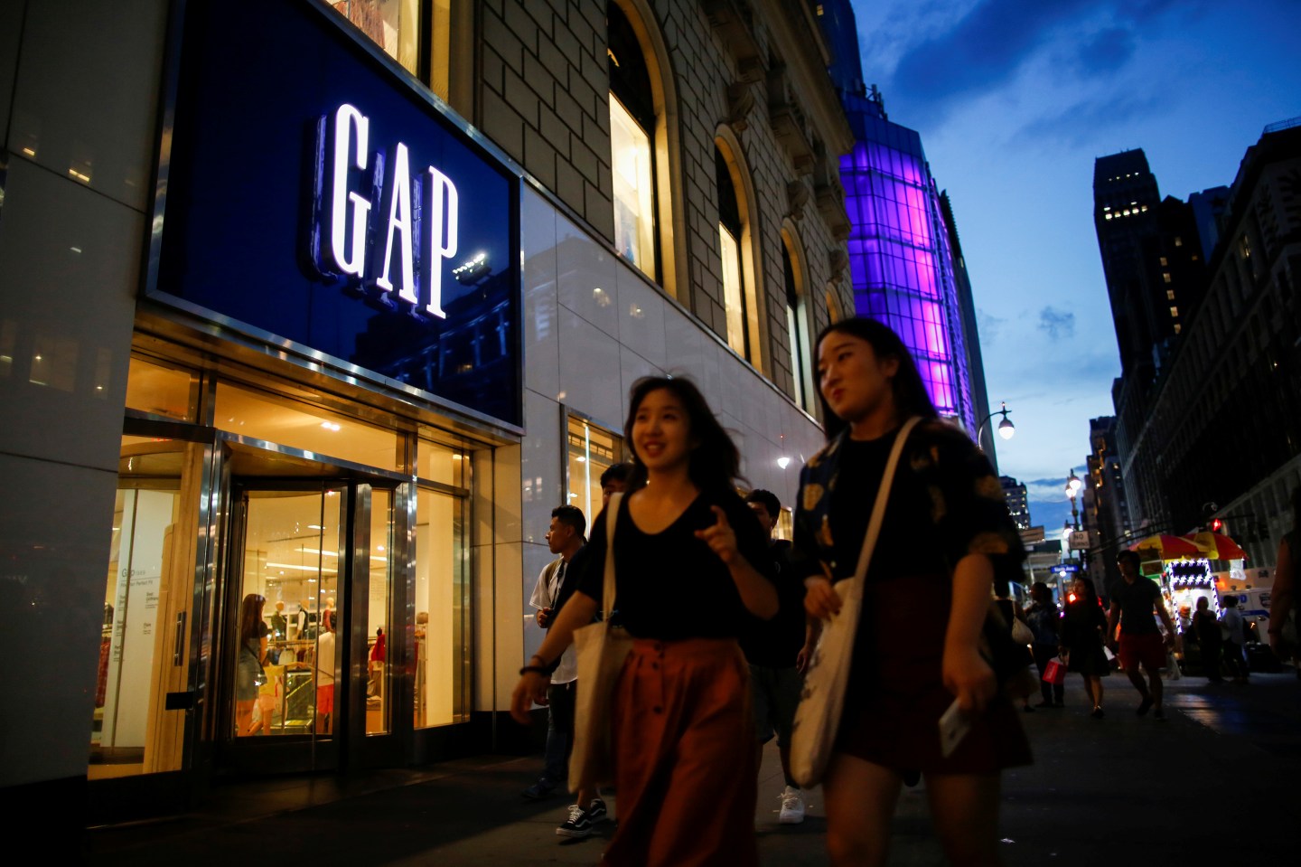 People pass by the GAP clothing retail store in Manhattan, New York, U.S., August 15, 2016.