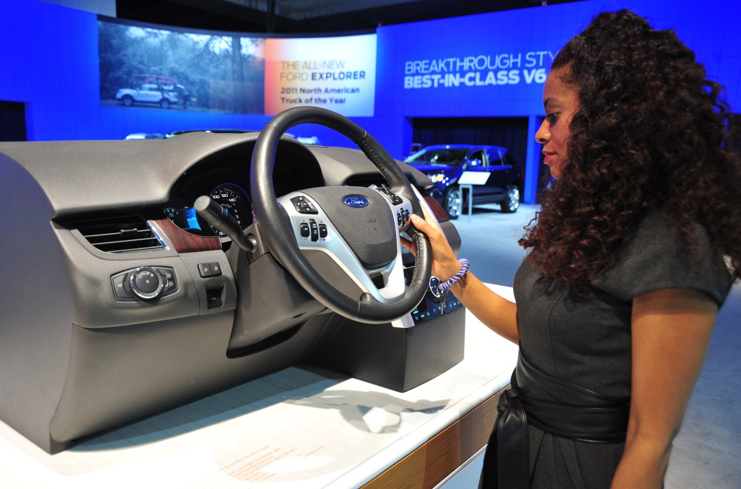 An auto show employee demonstrates Ford