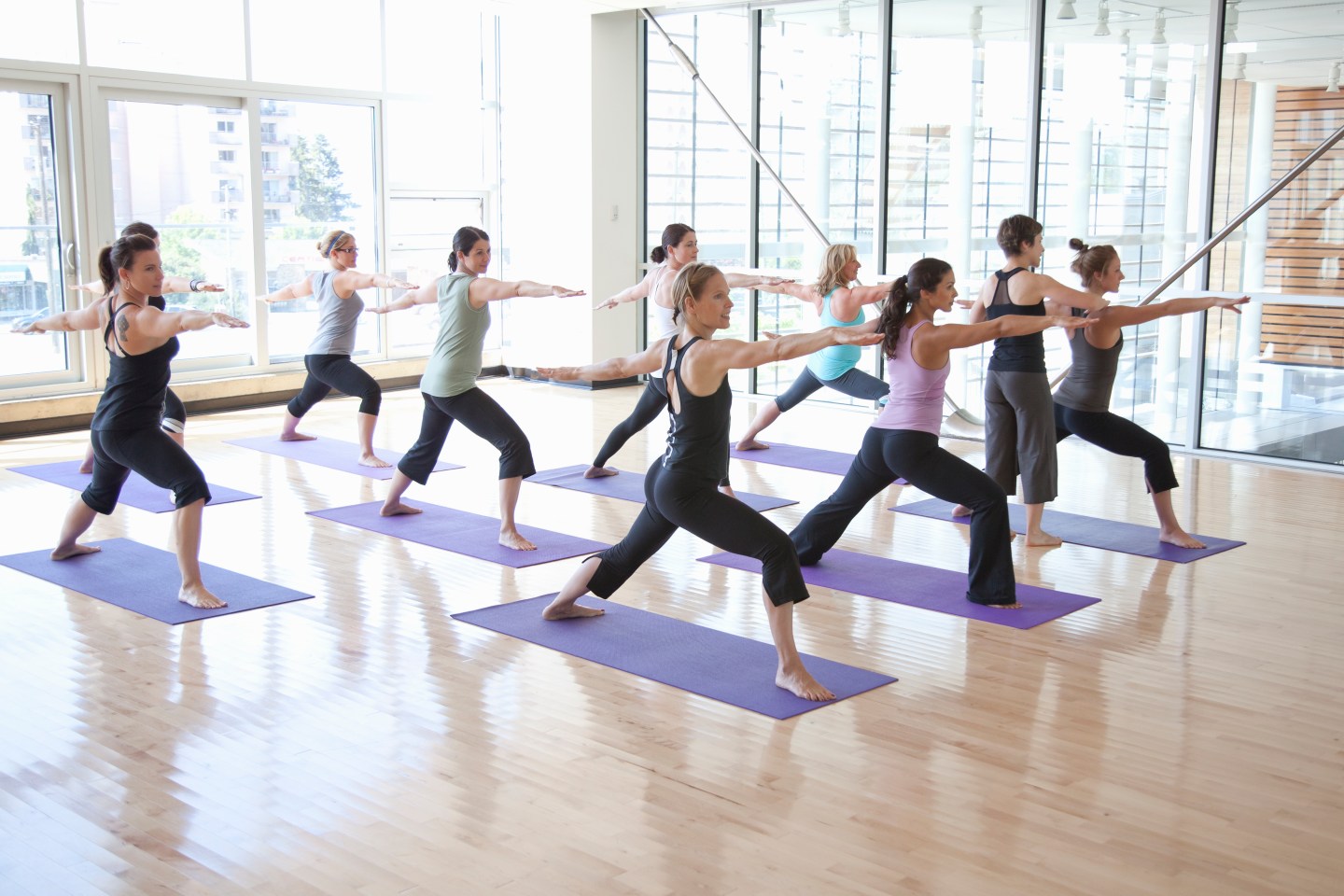 Yoga instructor guiding class through poses