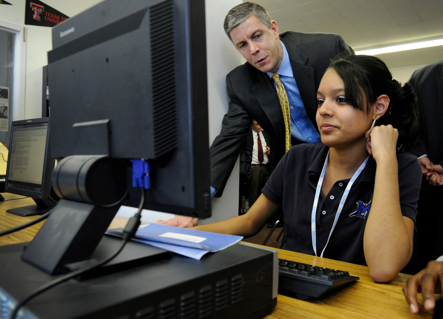 DENVER, CO--U.S. Secretary of Education, Arne Duncan, left, talks with Manual High School student, Karen Santoyo, 18-years-old, as she works on the computer at the Futures Center looking at colleges and financial aid Tuesday morning. Duncan held a communi