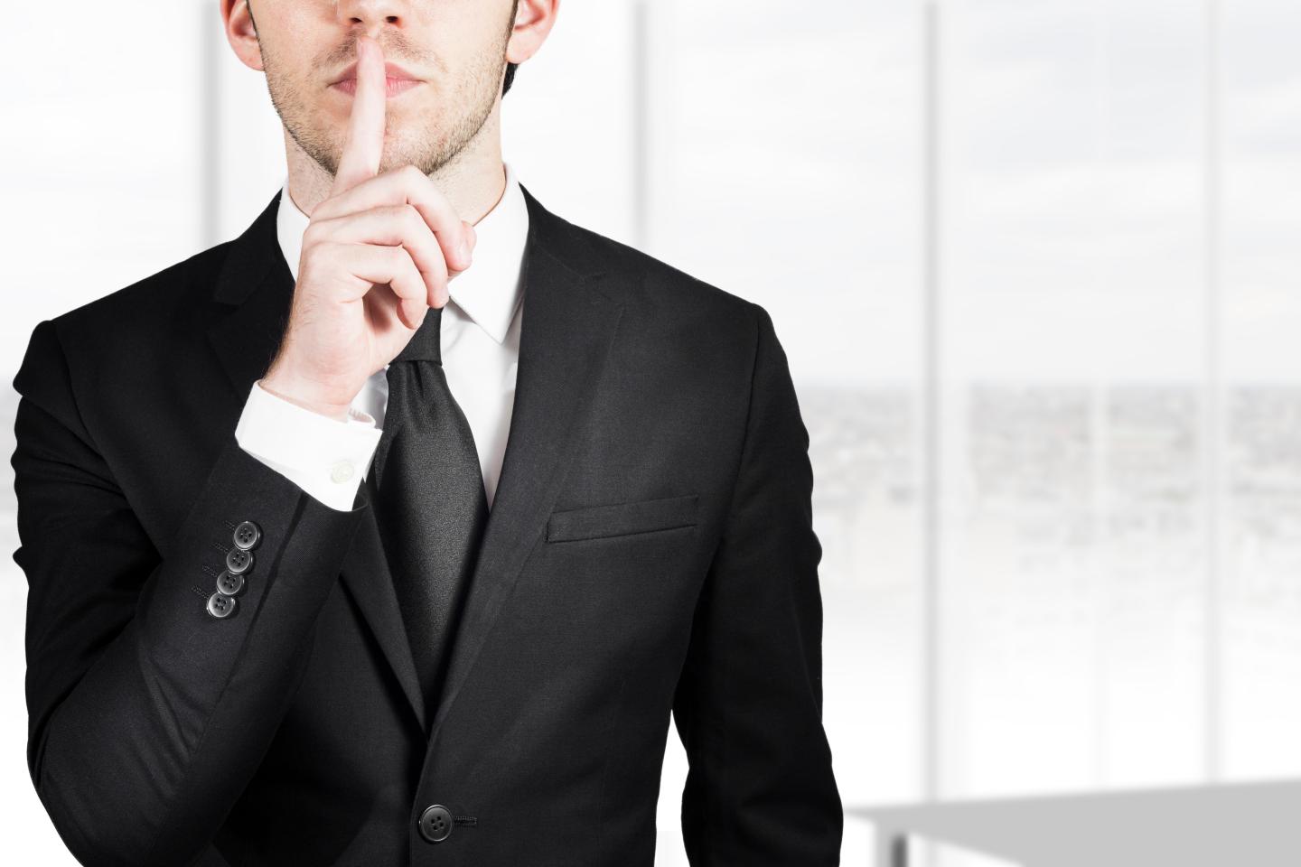 businessman silent quiet gesture
