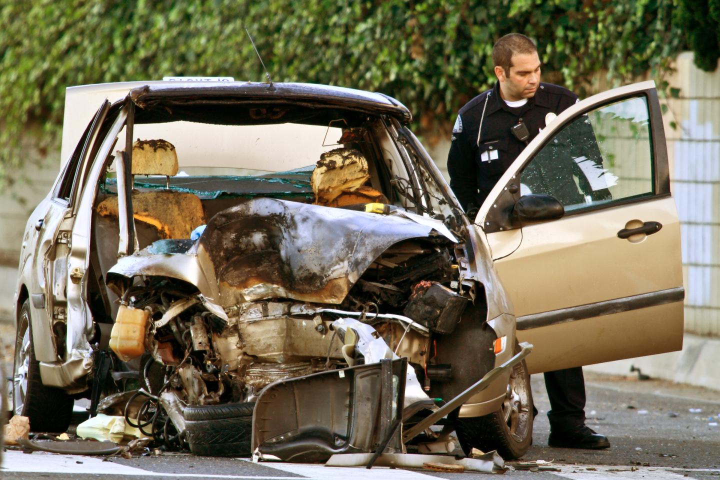 PACIFIC PALISADES, CA, August 03, 2011 ;  Investigators at the scene of an accident where a car sla