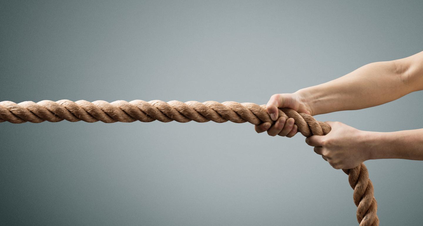 The hands of man pulling the rope