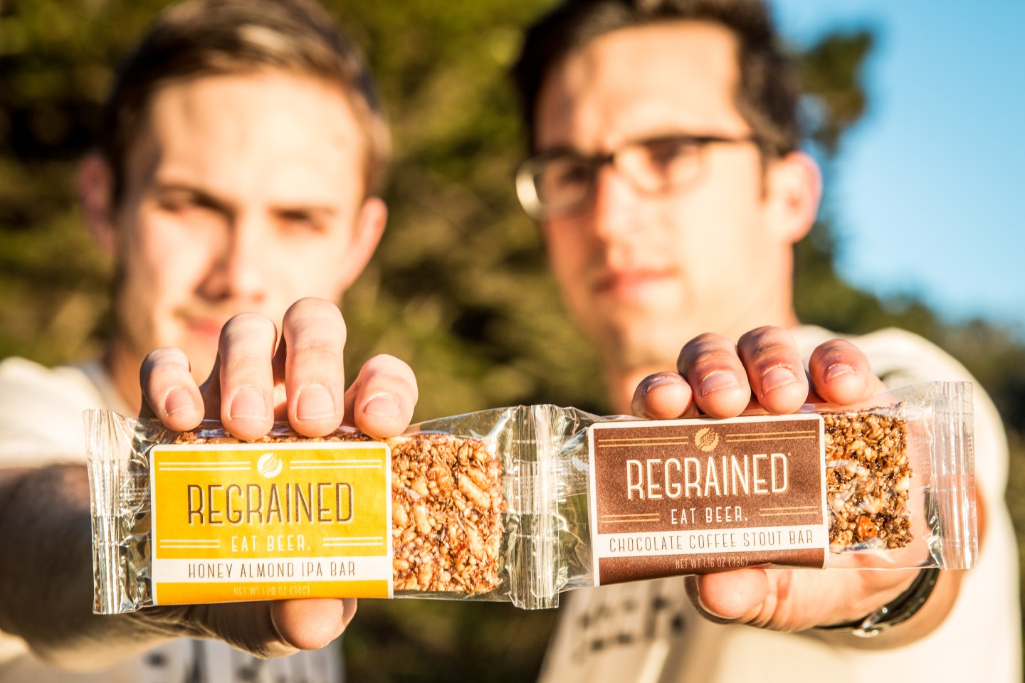 ReGrained founders Dan Kurzrock and Jordan Schwartz hold up their granola bars, which are made from used beer grain.