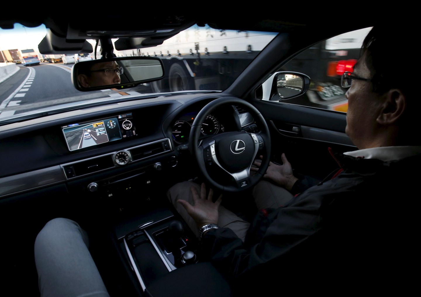 A staff member of Toyota Motor Corp drives its self-driving technology "Mobility Teammate Concept" prototype car hands-free on the Metropolitan Expressway during the Toyota Advanced Technologies media preview in Tokyo