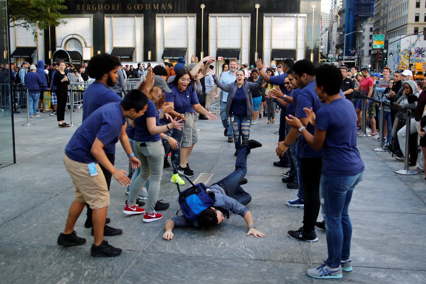 A customer falls down before going into the Apple Inc. store for buying the iPhone 7 smartphone in New York, U.S.