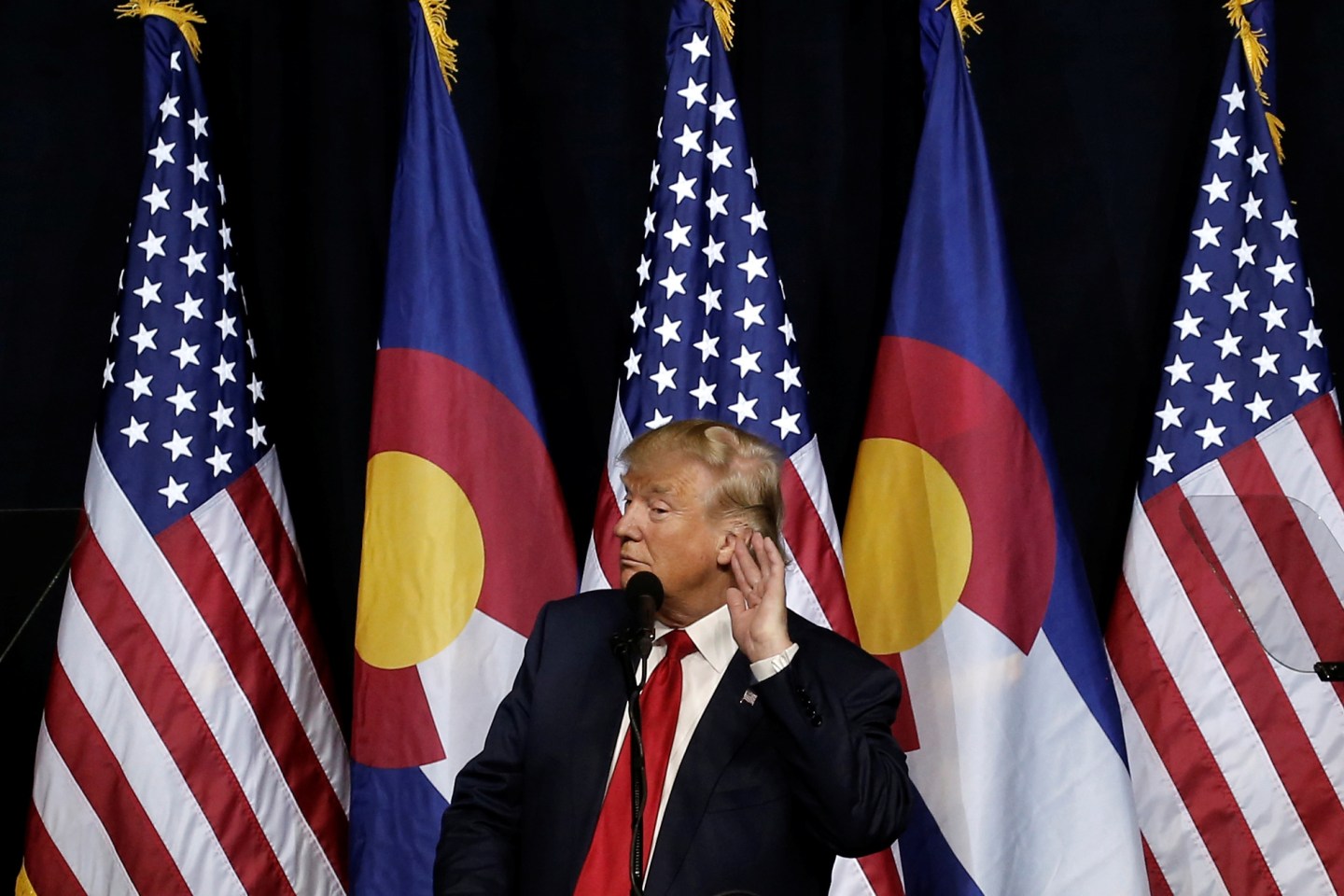 U.S. Republican presidential nominee Donald Trump puts his hand to his ear as he speaks at a campaign rally in Pueblo