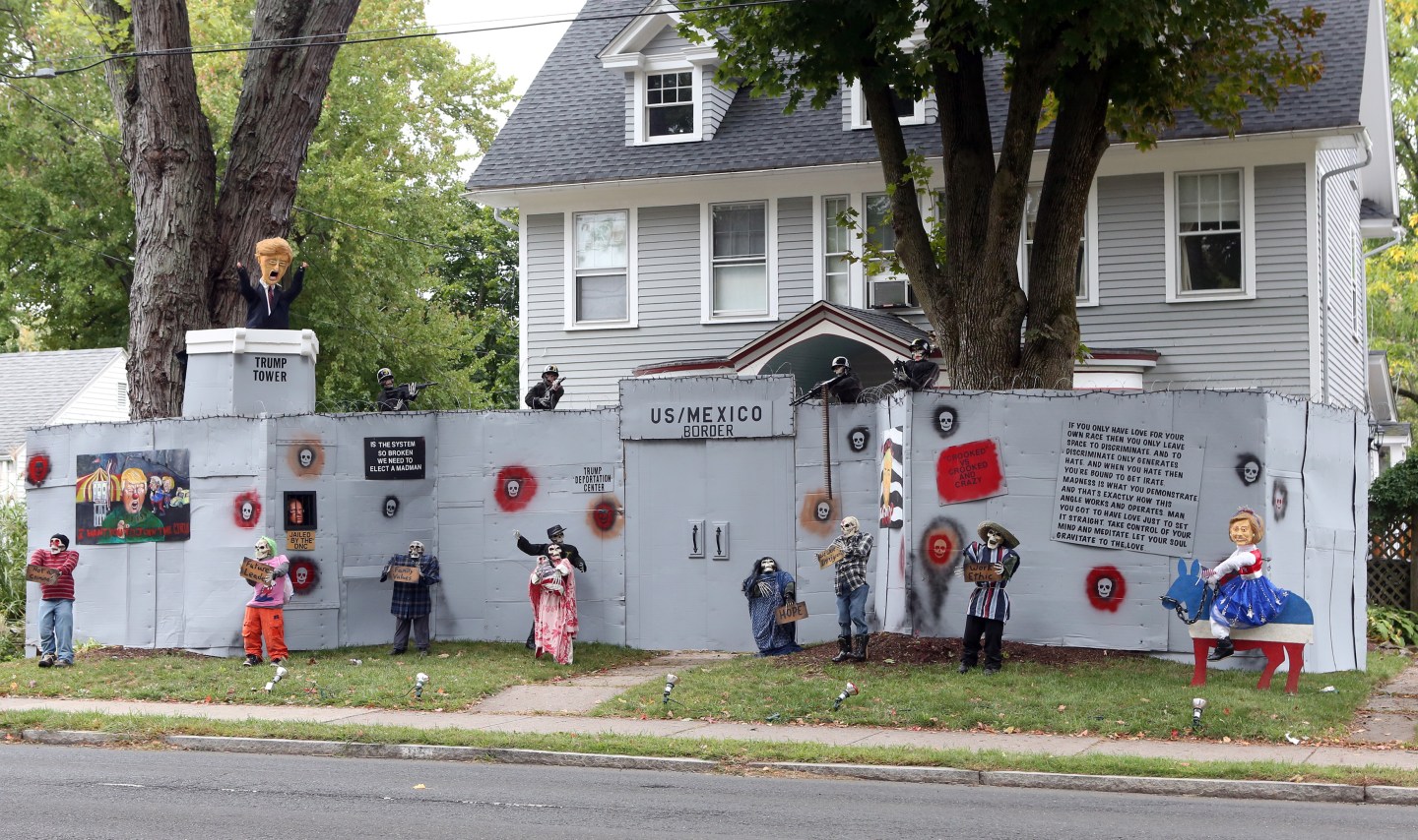 A Halloween display featuring a border wall and figures of Donald Trump, Hillary Clinton and Bernie Sanders is seen on the property of Matt Warshauer in West Hartford