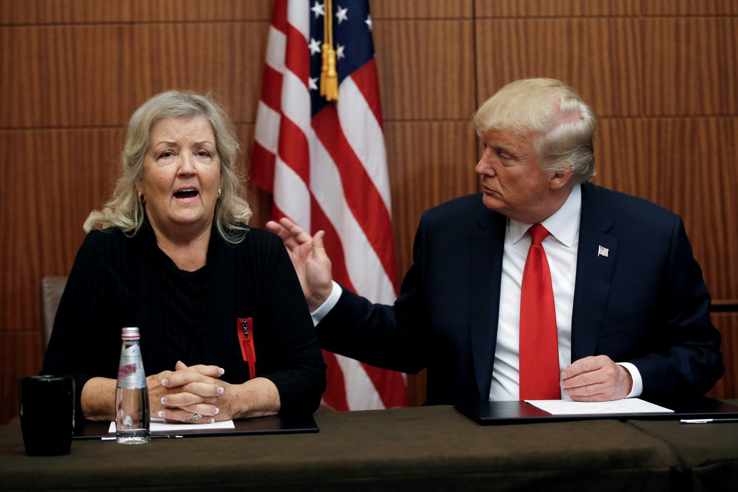Republican presidential nominee Donald Trump sits with Juanita Broaddrick, in a hotel conference room in St. Louis, Missouri