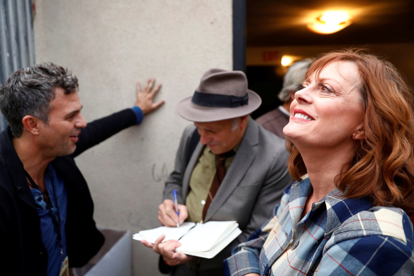 Actor Susan Sarandon smiles during an interview with author Greg Palast and Mark Ruffalo backstage at a climate change rally in solidarity with protests of the pipeline in North Dakota at MacArthur Park in Los Angeles, California