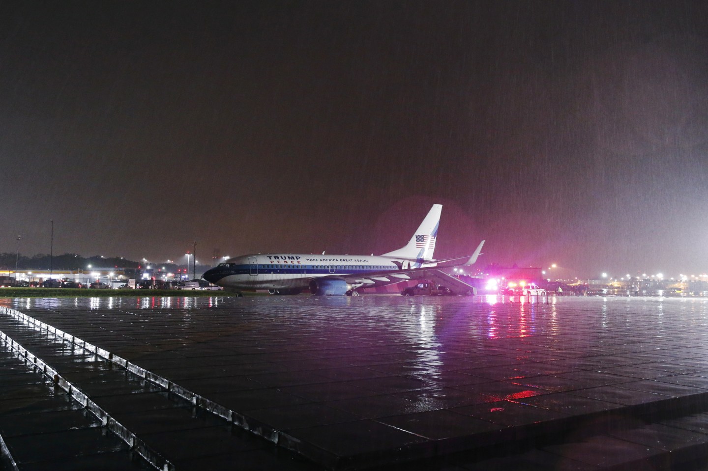 A campaign plane that had been carrying Mike Pence rests in the grass after it skidded off the runway while landing in the rain at LaGuardia Airport in New York