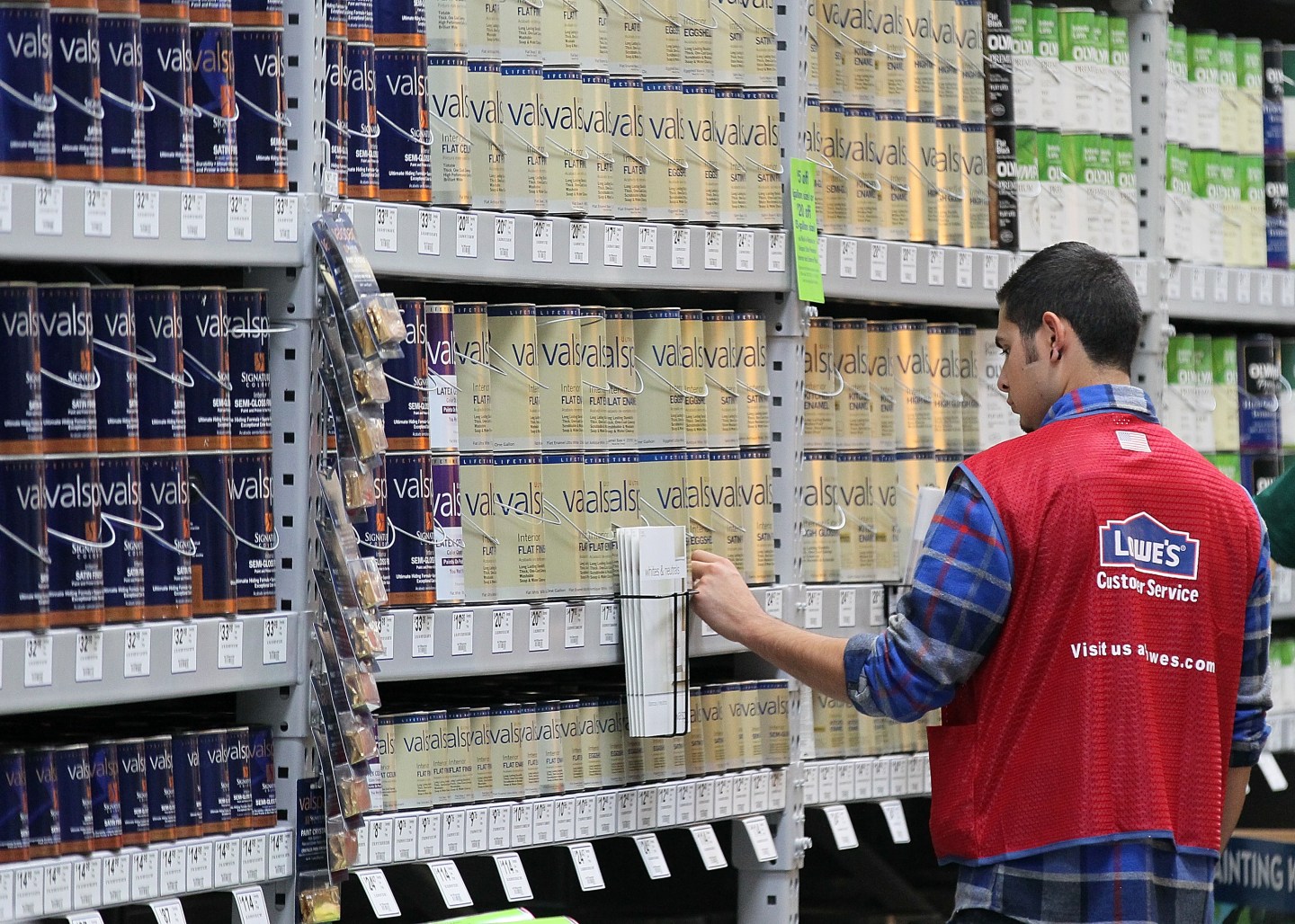 A Lowe's employee checks paint inventory in San Francisco store.
