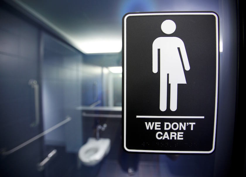 File photo of a sign protesting a recent North Carolina law restricting transgender bathroom access adorns one of the stalls at the 21C Museum Hotel in Durham, North Carolina