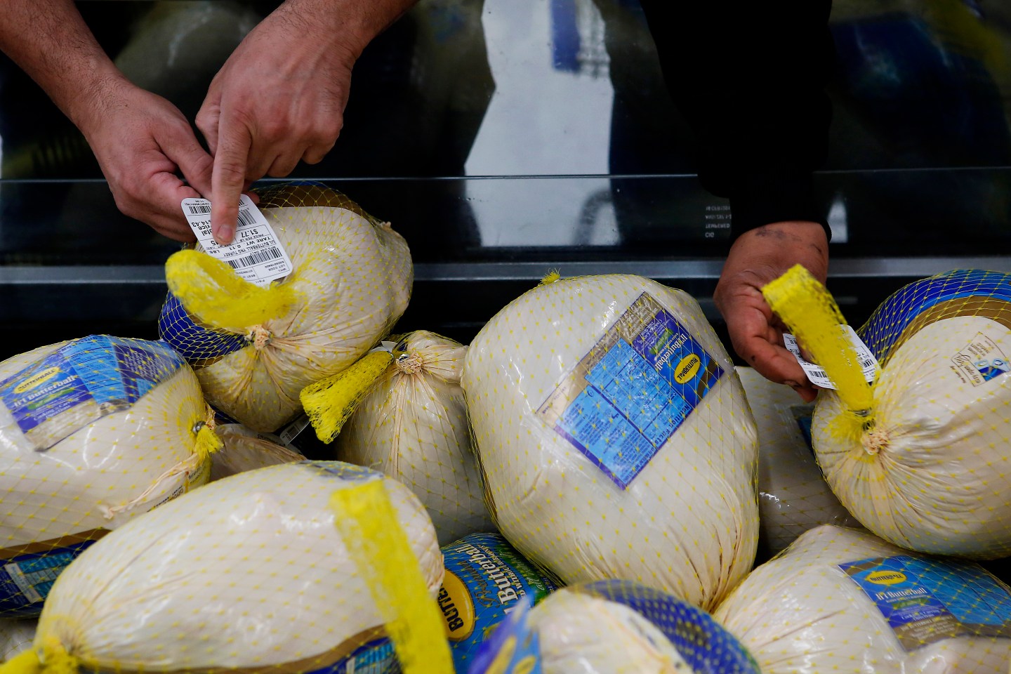Customers check the price tag on a Butterball frozen turkey at a Walmart in Los Angeles.