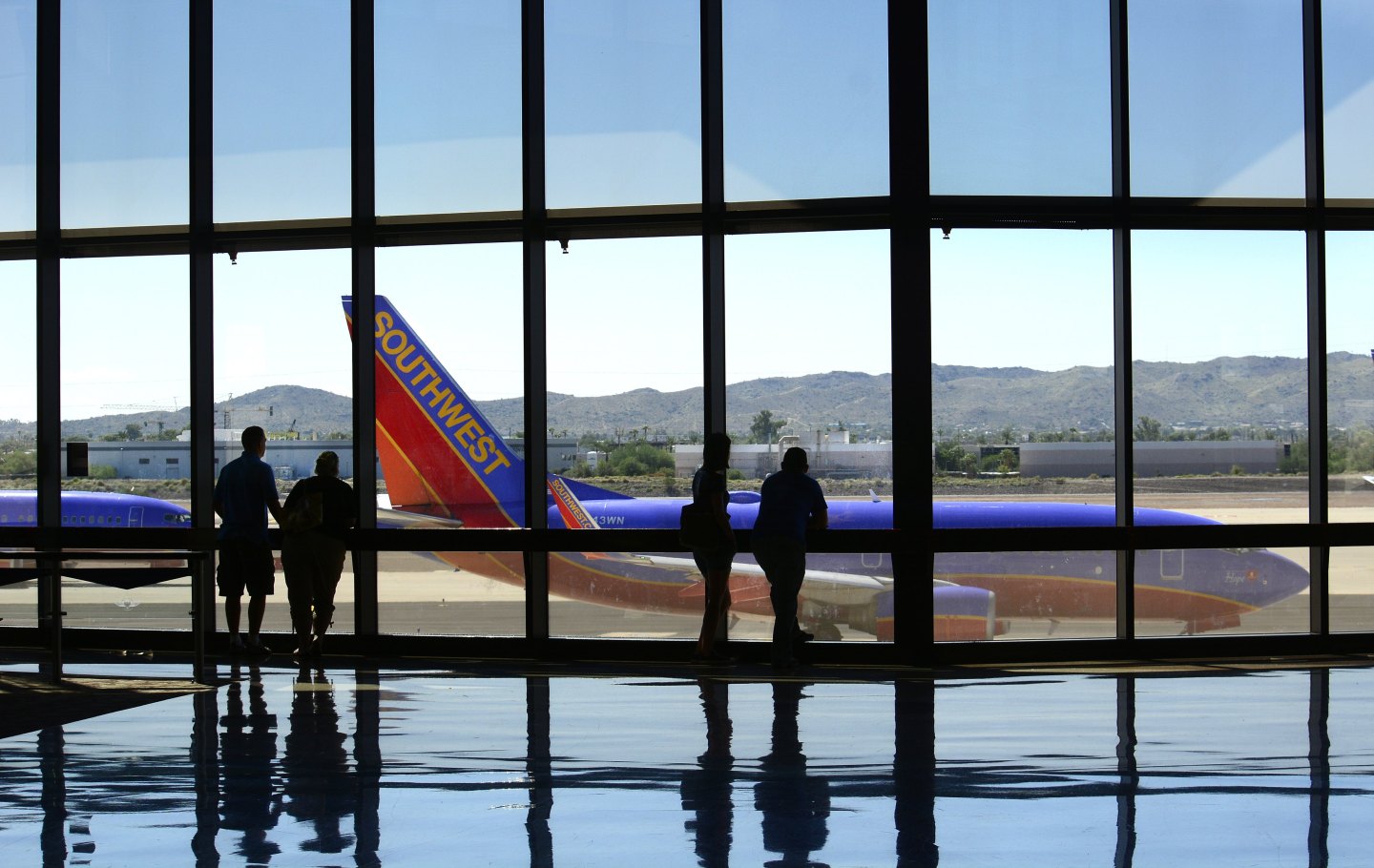 Airline passengers wait for their flights at Phoenix Sky Harbor International Airport.