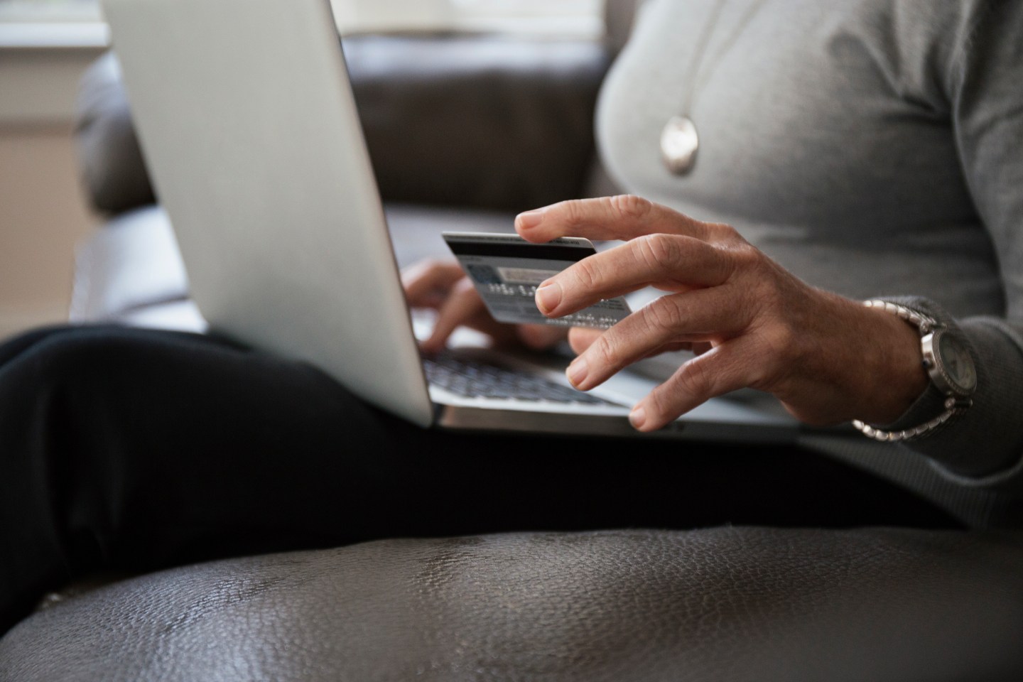Close up of senior woman buying online at home