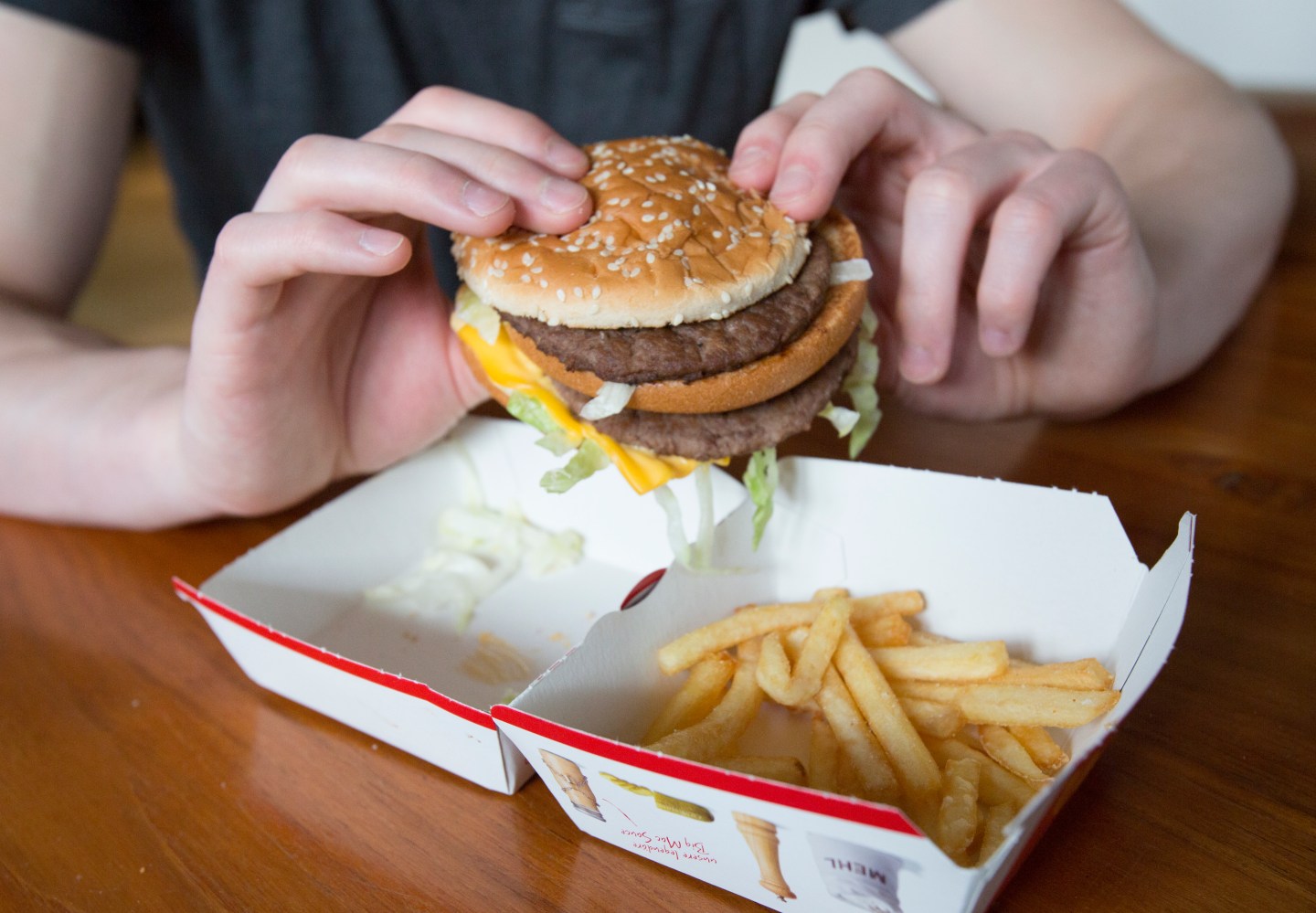 Man holds a Big Mac from McDonald’s.