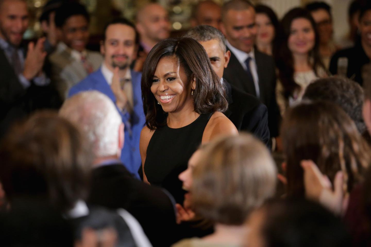 First lady Michelle Obama (C) arrives for an event in the East Room of the White House.