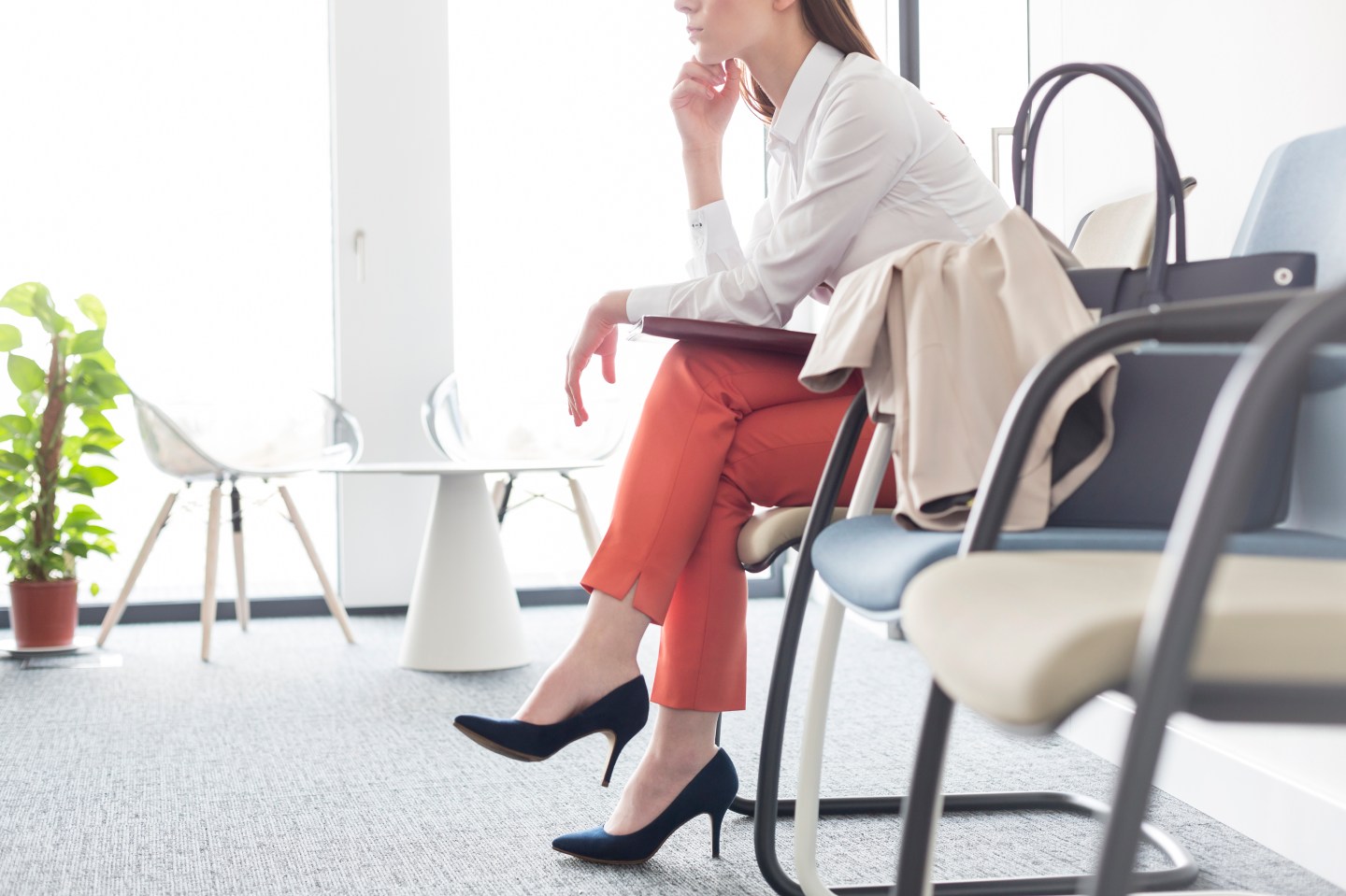 Businesswoman waiting with legs crossed in lobby