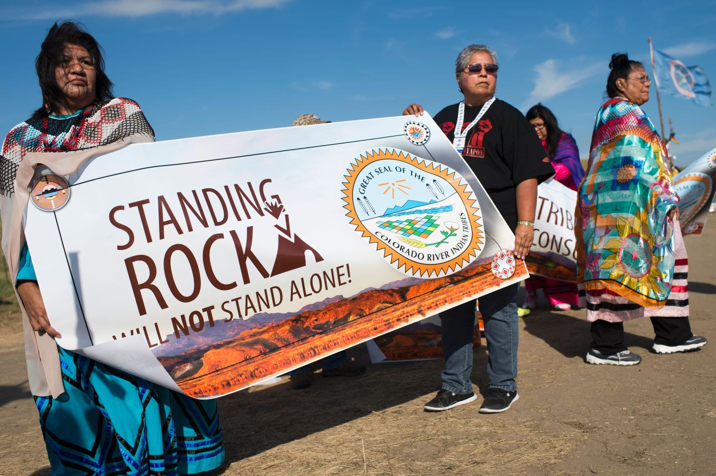 Members of the Colorado River Tribes hold a banner to show their support for those who oppose the construction of the Dakota Access Pipeline.
