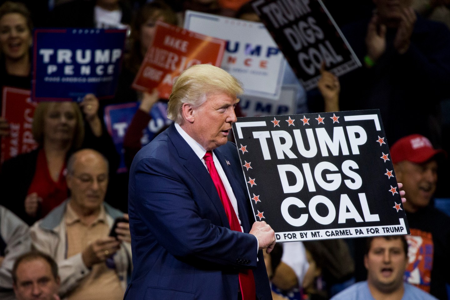 Donald Trump holds a sign supporting coal during a rally at Mohegan Sun Arena in Wilkes-Barre, Pennsylvania.