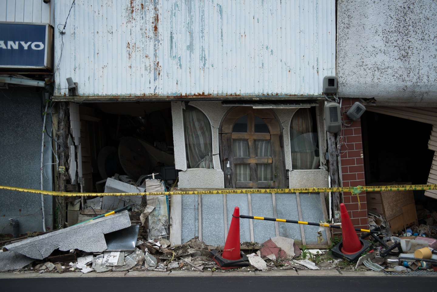 A caution tape is seen in front of a store damaged by the 2011 earthquake and tsunami in Namie, Fukushima.