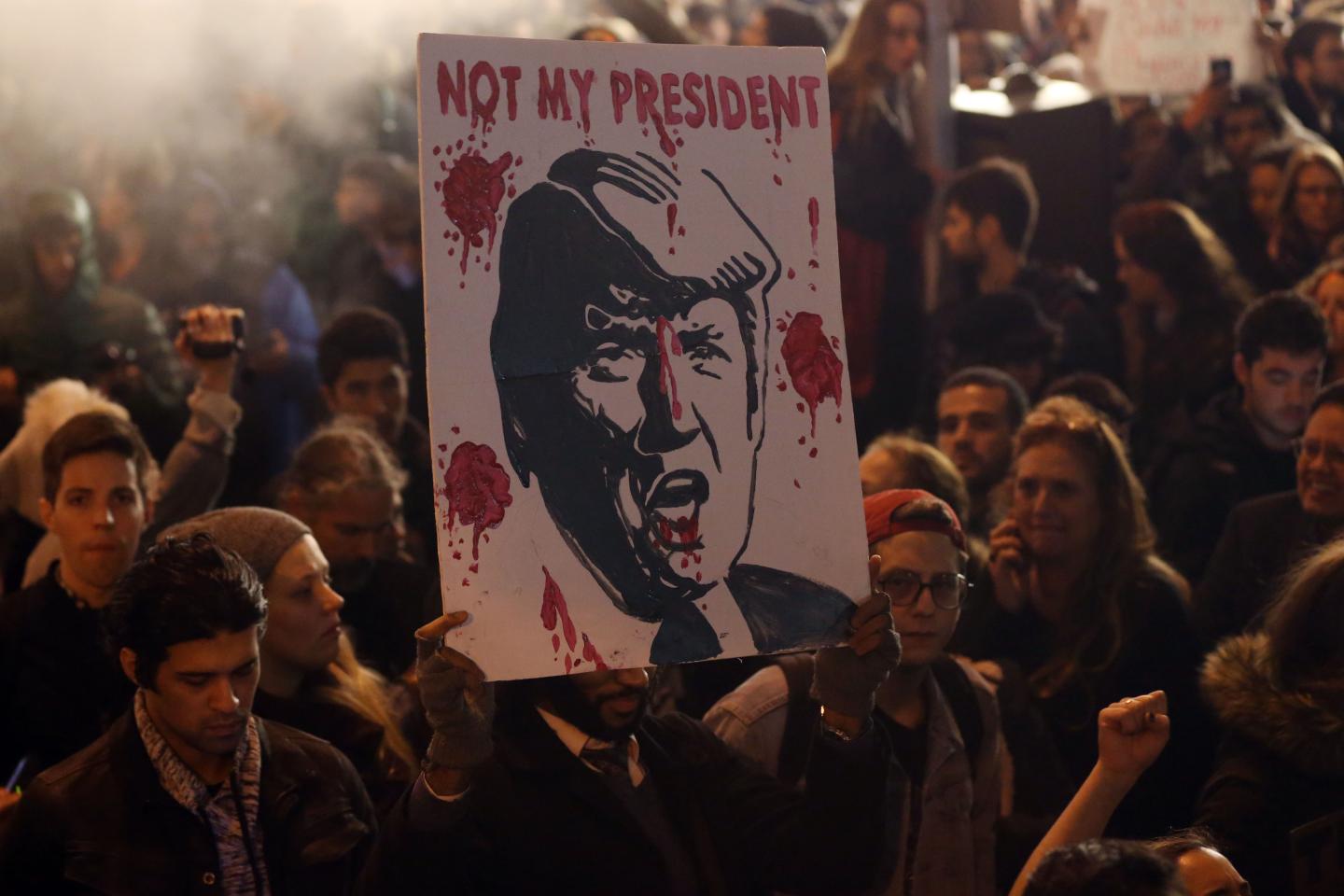 Protestors gather outside Trump Tower during a protest in New York, United States on November 9, 2016.