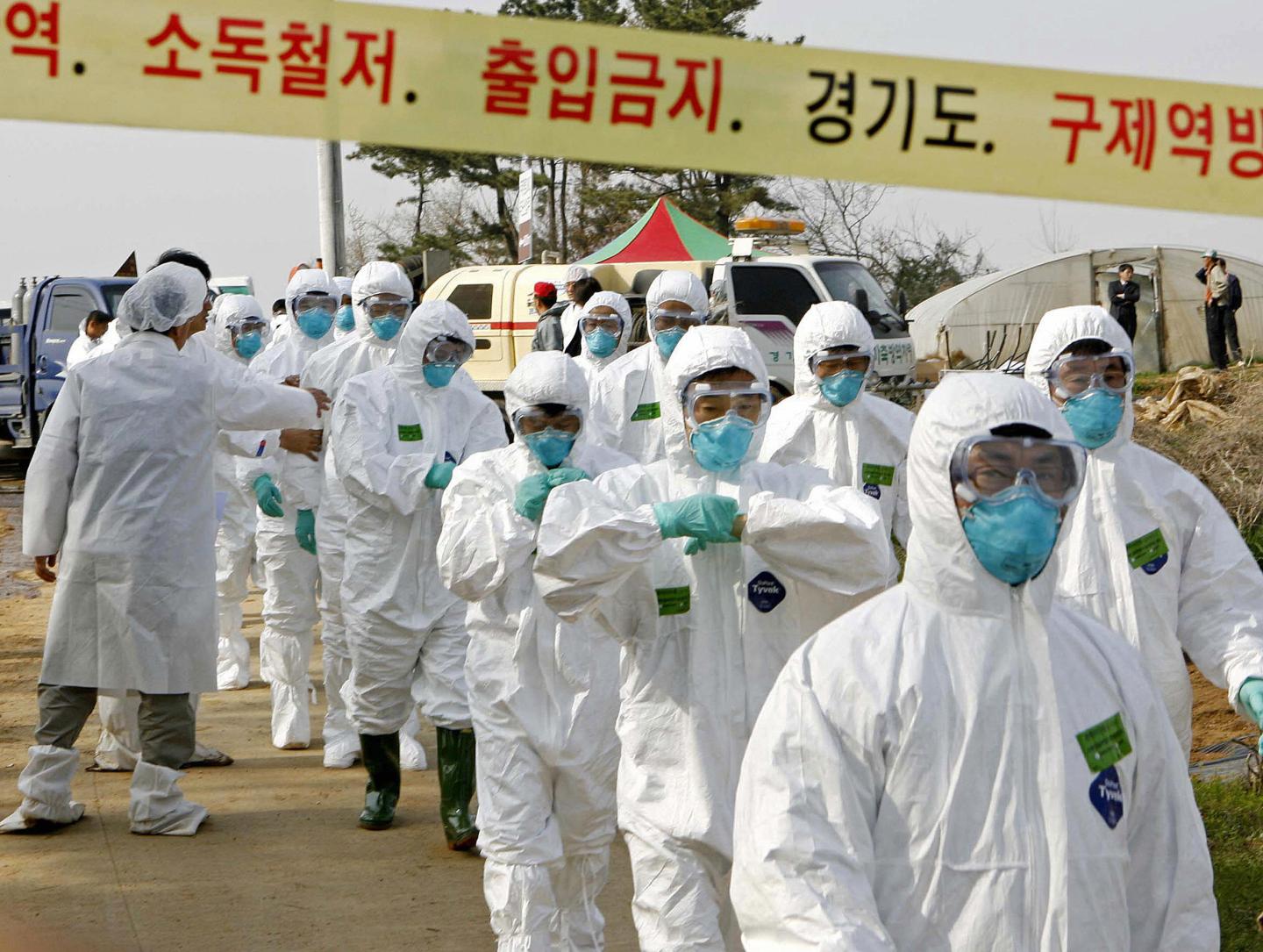 South Korean quarantine officials march