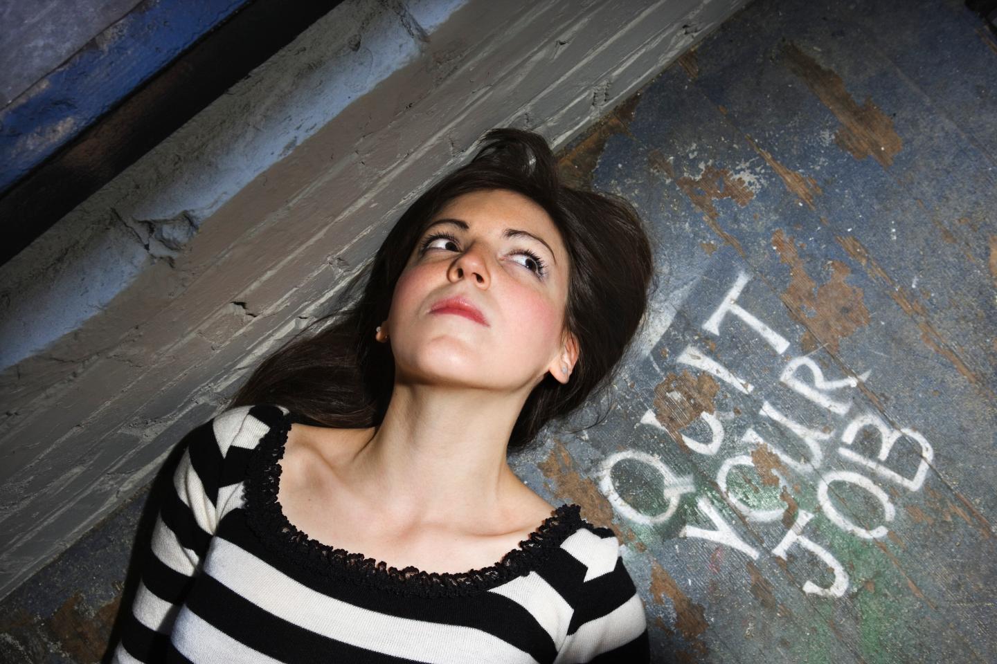 Woman lying beside quit your job message