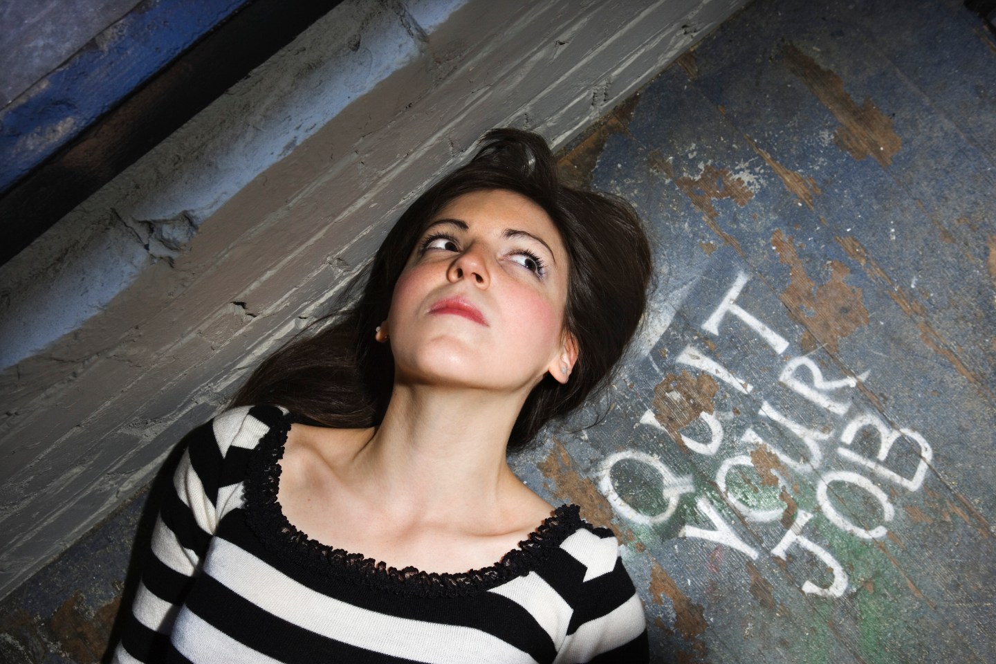 Woman lying beside quit your job message