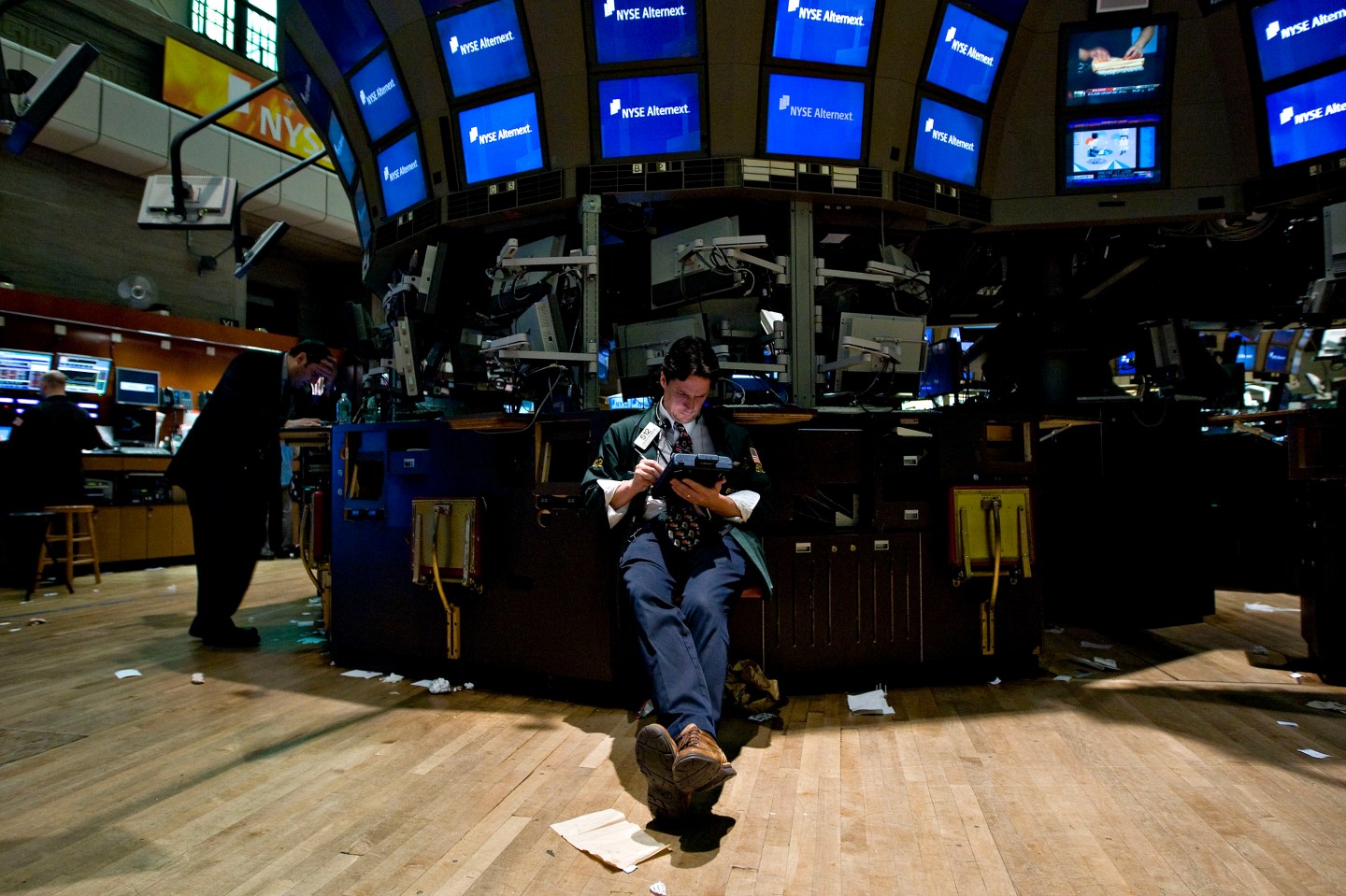 A trader works at a vacant post on the floor of the New York