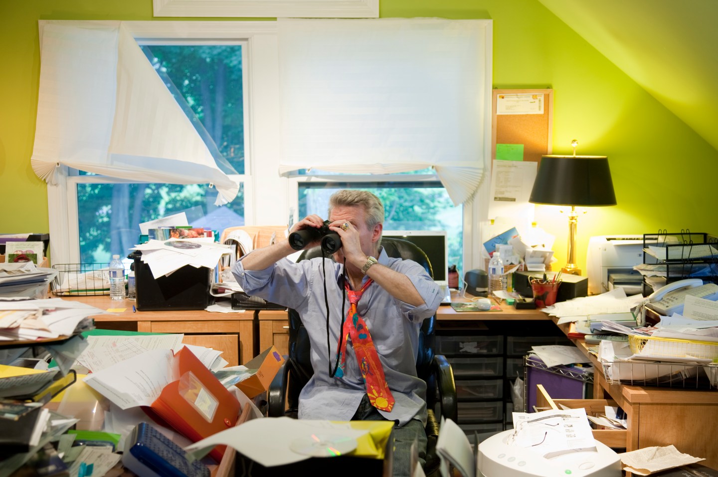 Baby Boomer w/ Binoculars in Messy Office