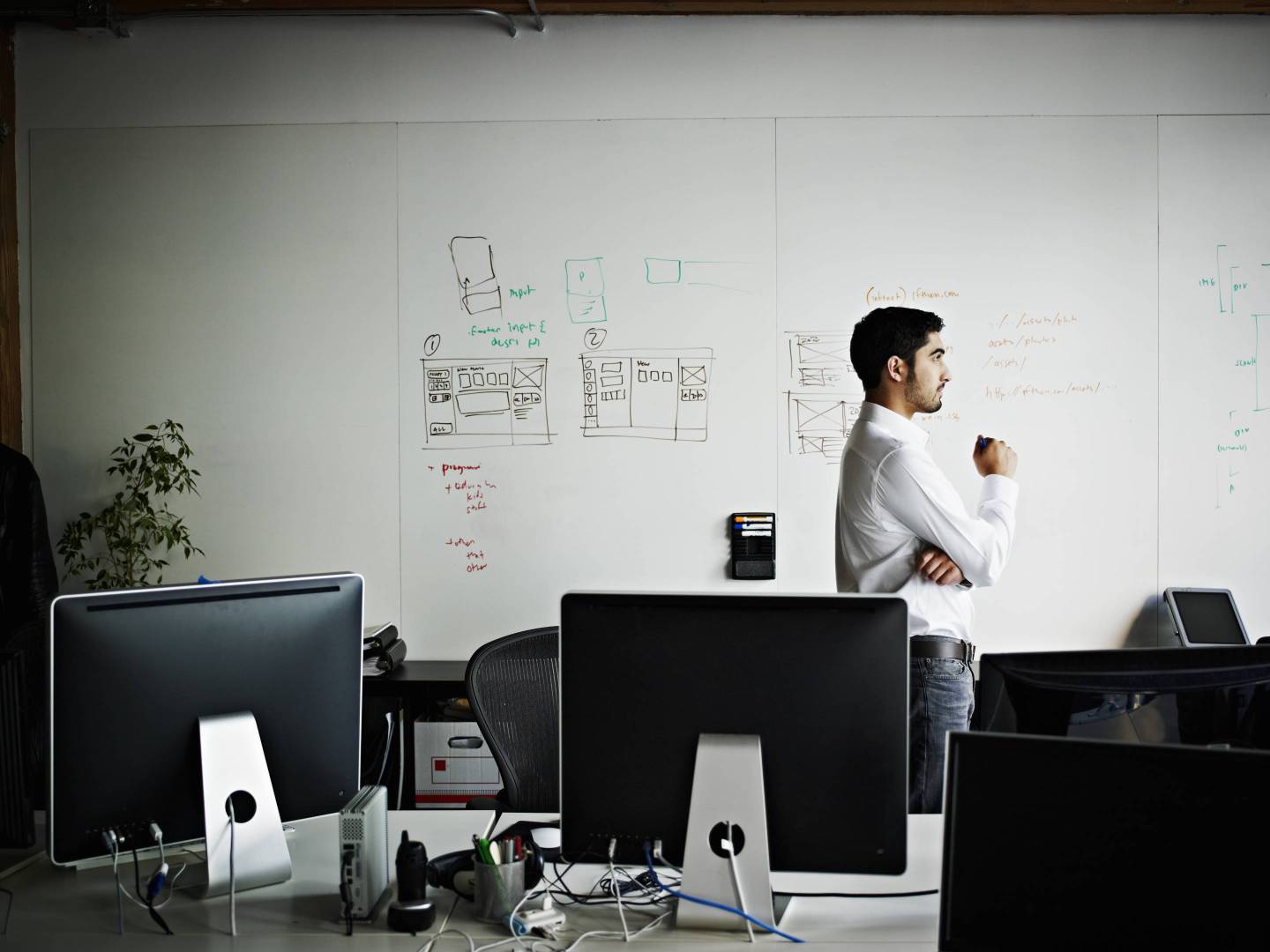 Businessman standing in office looking out