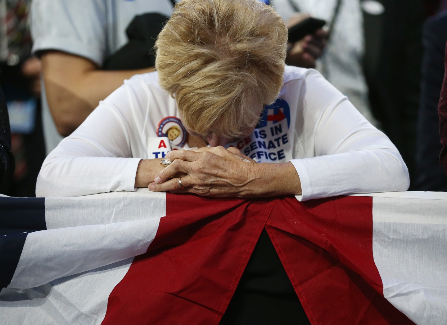 Supporter of Democratic presidential nominee Hillary Clinton watbows head at her rally in New York