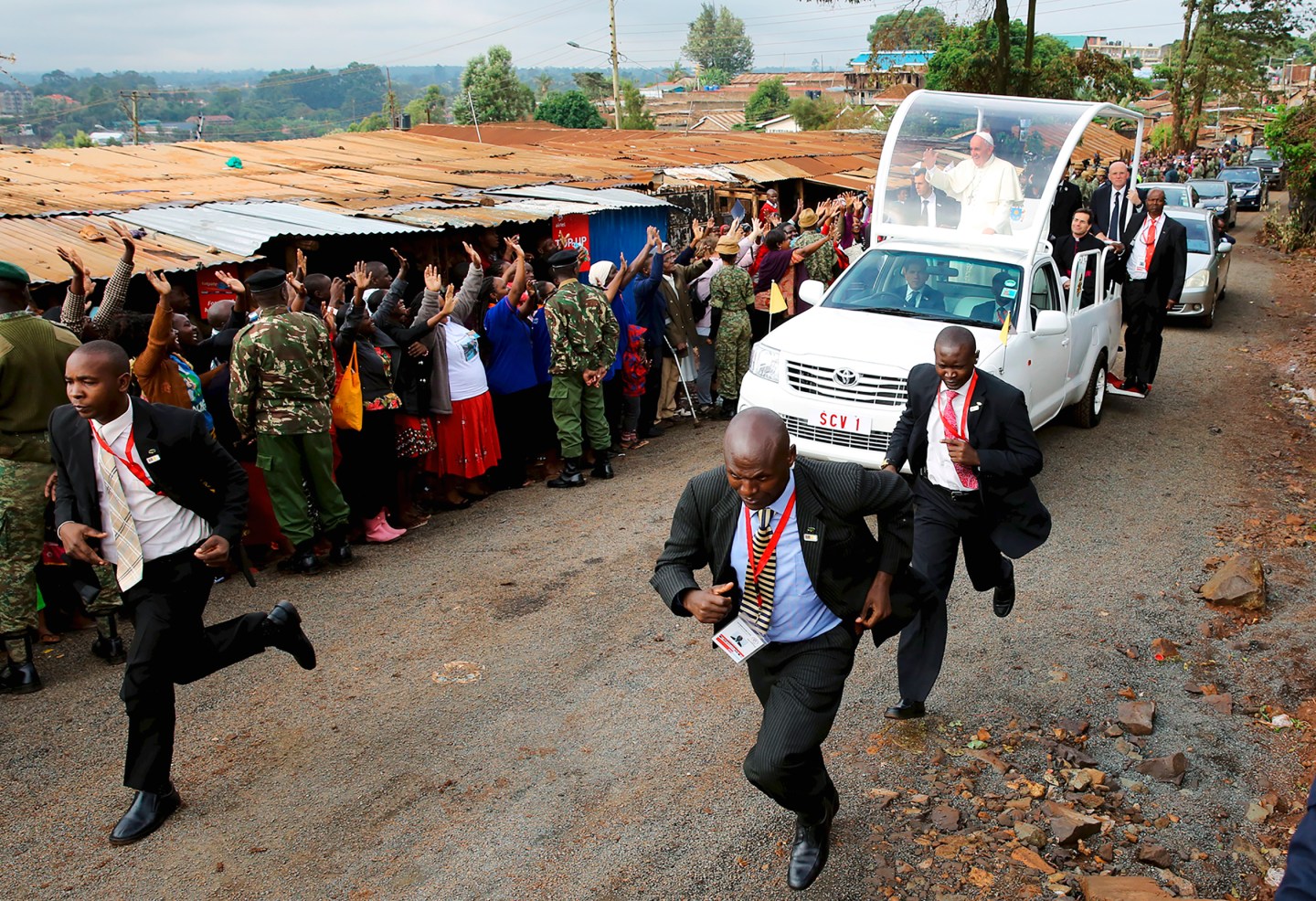 Pope Francis waves as he arrives at the Kangemi slums on the outskirts of Kenya's capital Nairobi