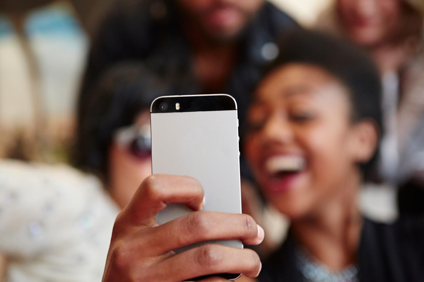 Group of friends taking a selfie with cell phone