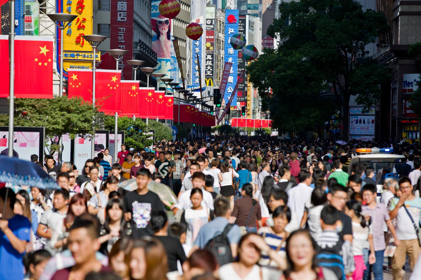 Chinese national flags are seen as tourists crowd along the Nanjing Pedestrian Road, a main shopping area, during national day holidays, in Shanghai